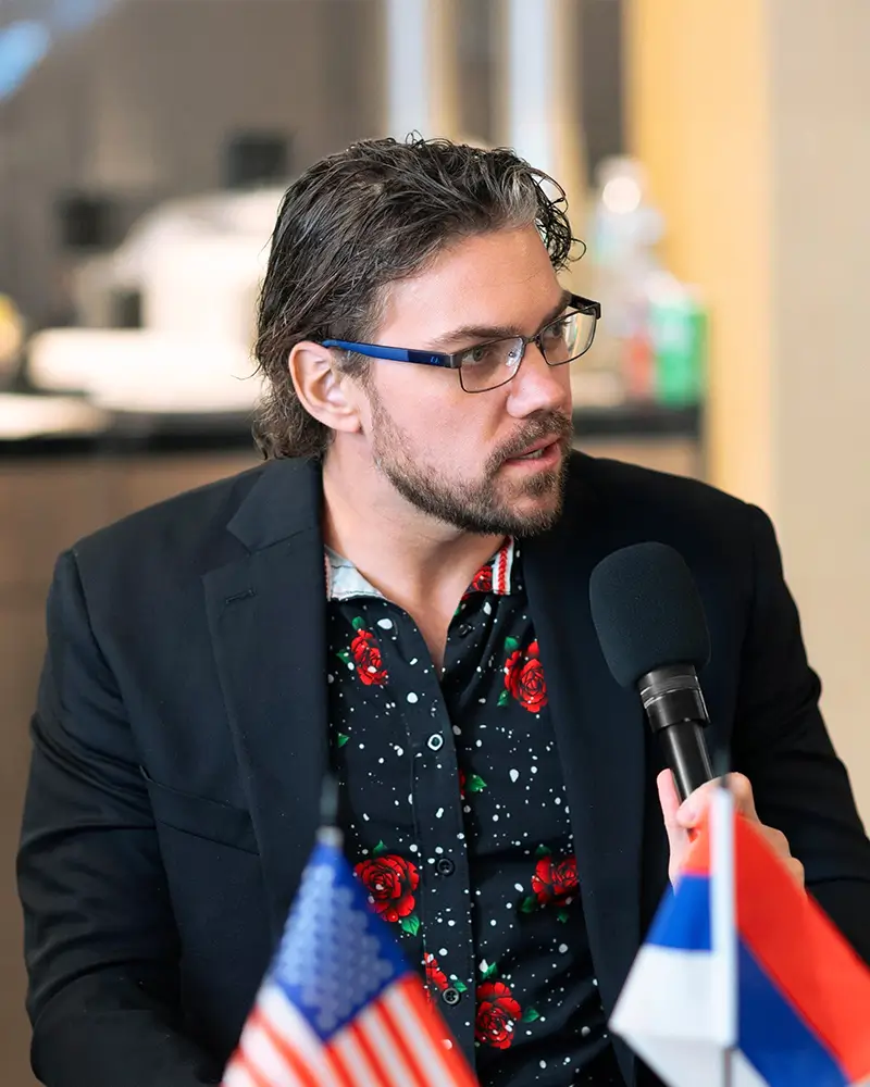 Michael Griswold speaking at a microphone