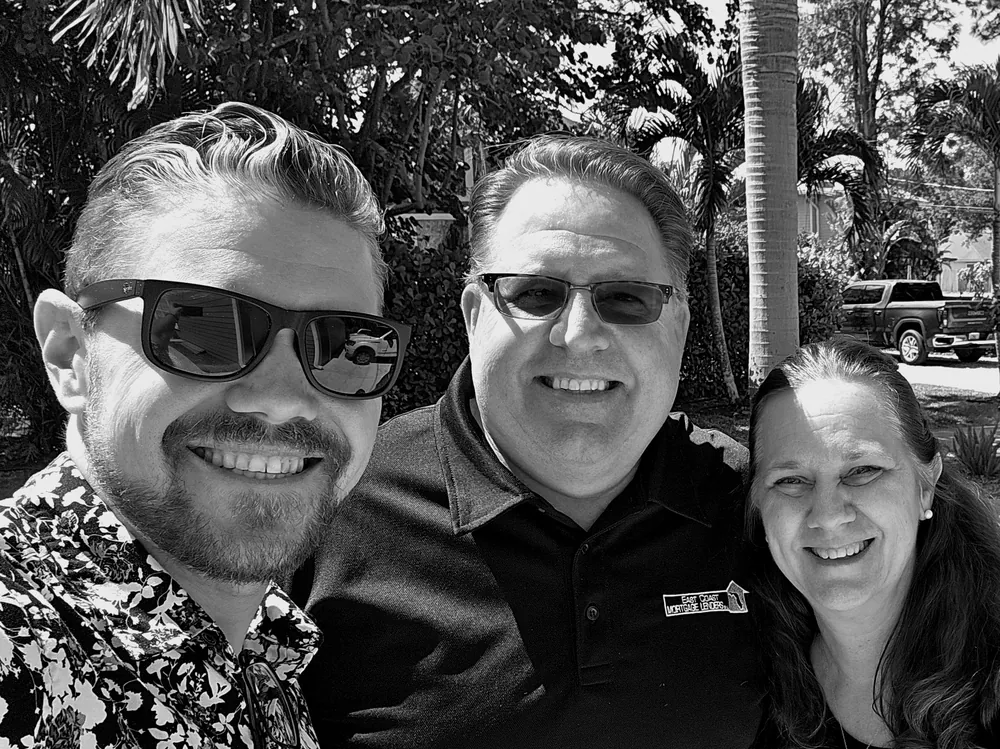 Michael Griswold with two guests outdoors at an event